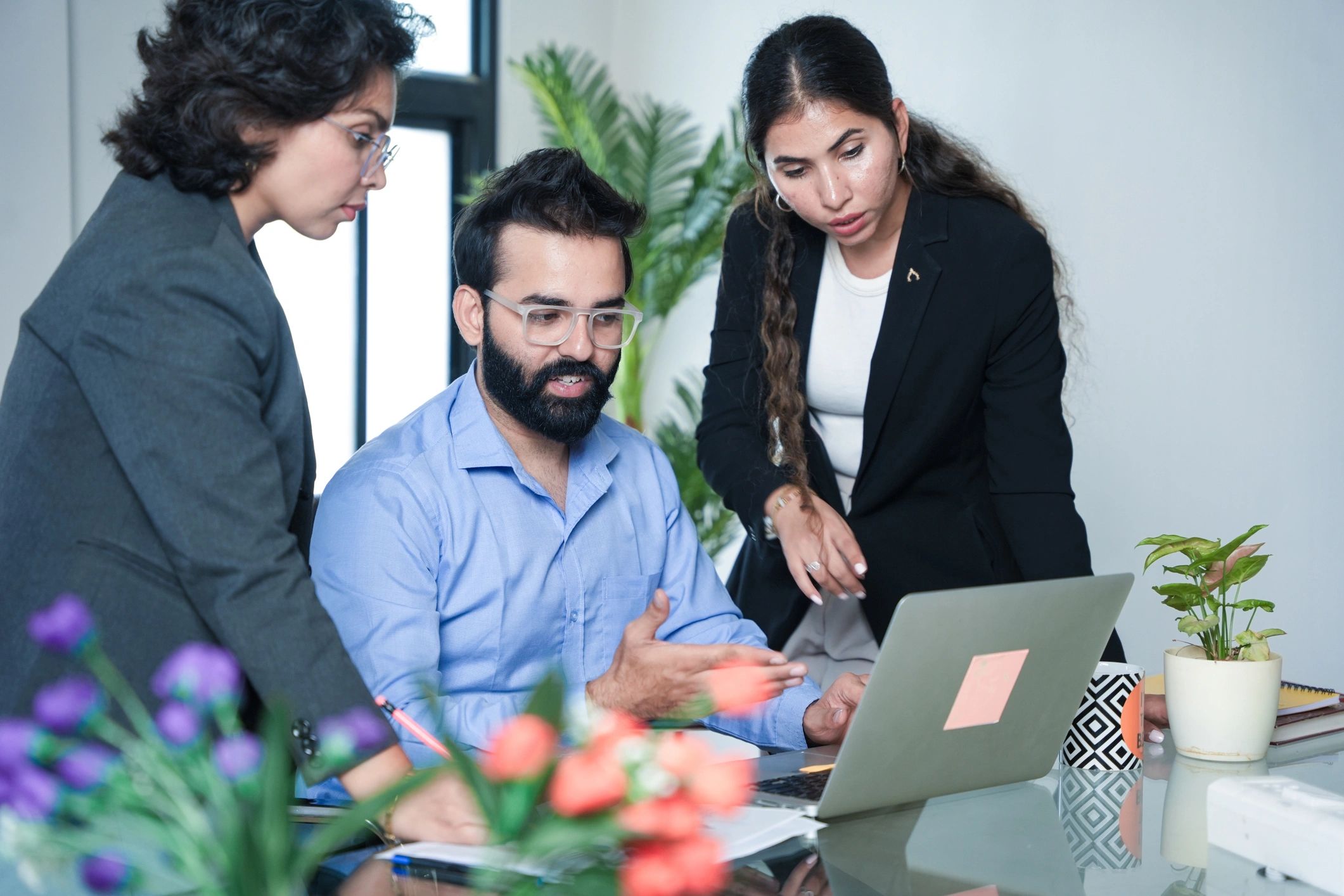 Team collaborating around a laptop during a planning session