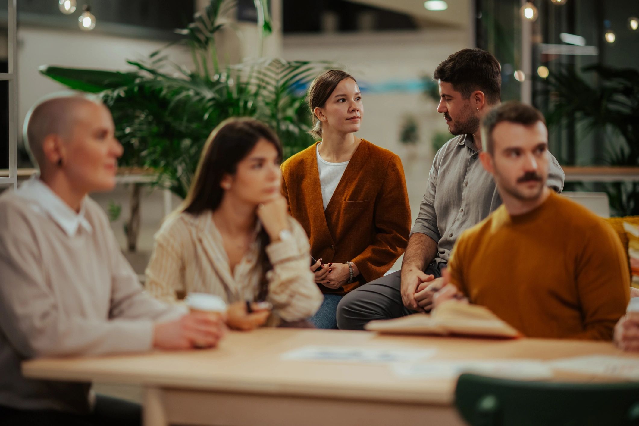 Diverse business team discussing ideas during brainstorming meeting
