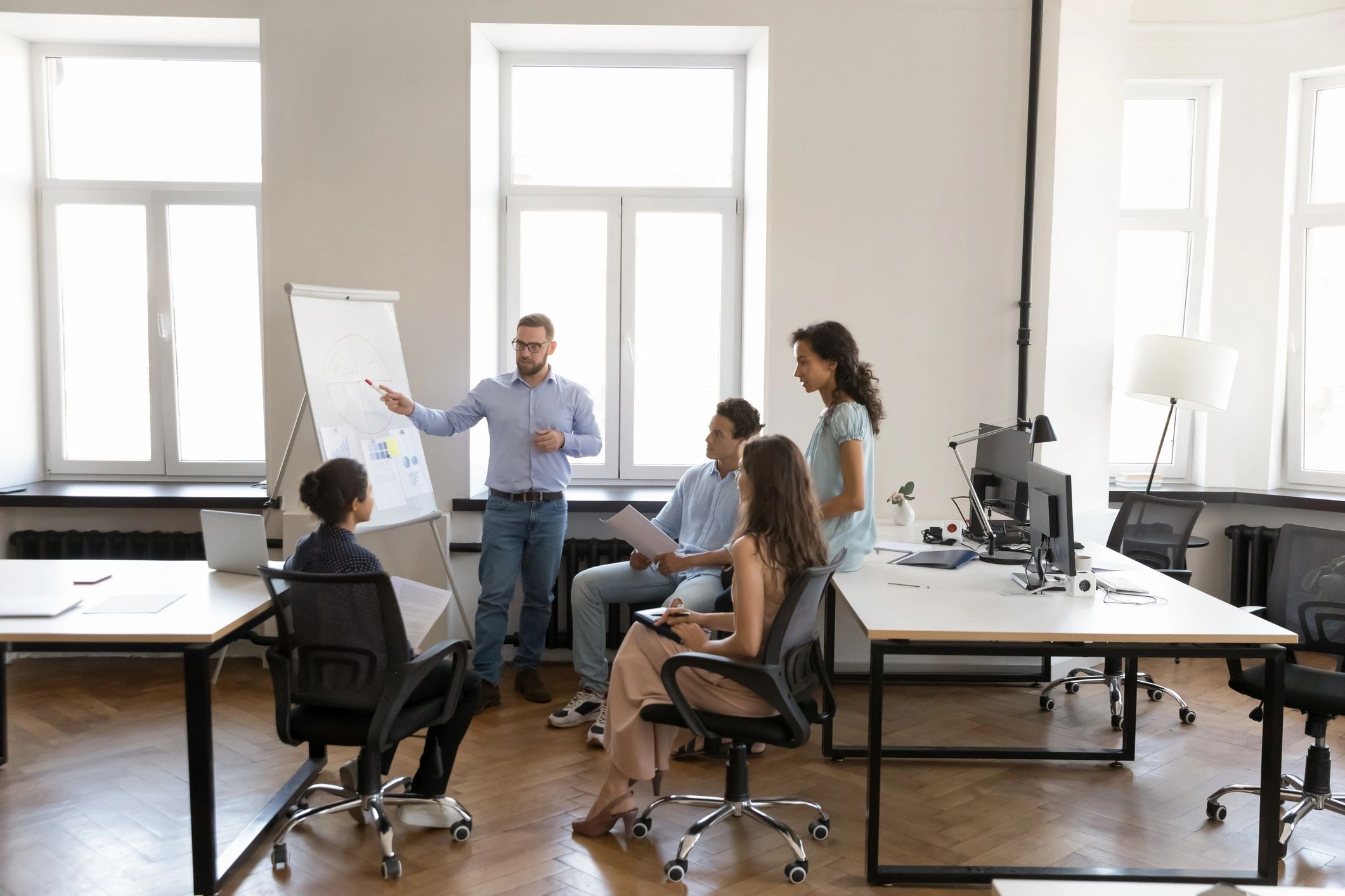 Indian professionals in a team workshop discussing strategy in a modern office
