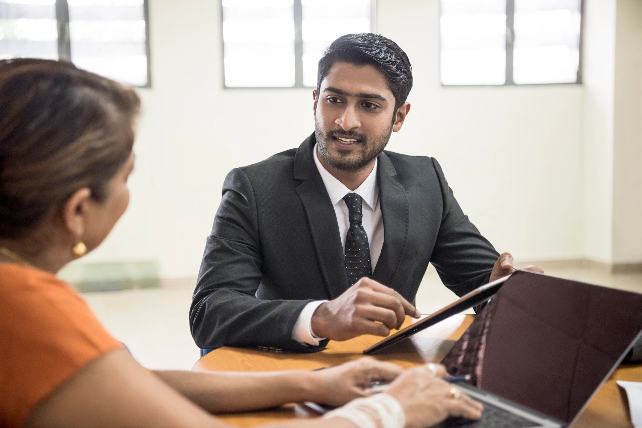 Young Sri Lankan businessman discussing with colleague